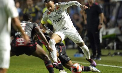 Brazil's Neymar is tackled as he chases a ball during his debut for Santos FC in a Sao Paulo league soccer match against Botafogo-SP, in Santos, Brazil, Wednesday, Feb. 5, 2025. (AP Photo/Andre Penner)