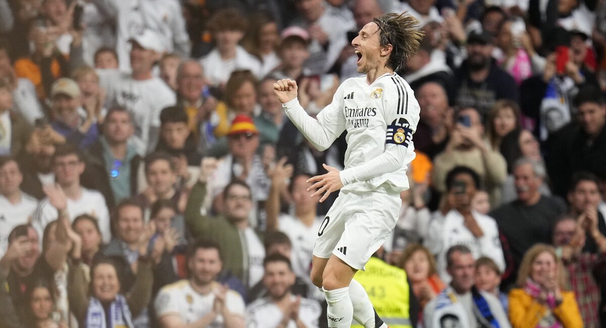 Real Madrid's Luka Modric celebrates after scoring the opening goal during the Spanish La Liga soccer match between Real Madrid and Girona at the Santiago Bernabeu stadium in Madrid, Spain, Sunday, Feb. 23, 2025. (AP Photo/Manu Fernandez)