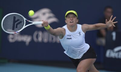 Iga Swiatek, of Poland, hits a return to Caroline Garcia, of France, during the Miami Open tennis tournament, Friday, March 21, 2025, in Miami Gardens, Fla. (AP Photo/Lynne Sladky)