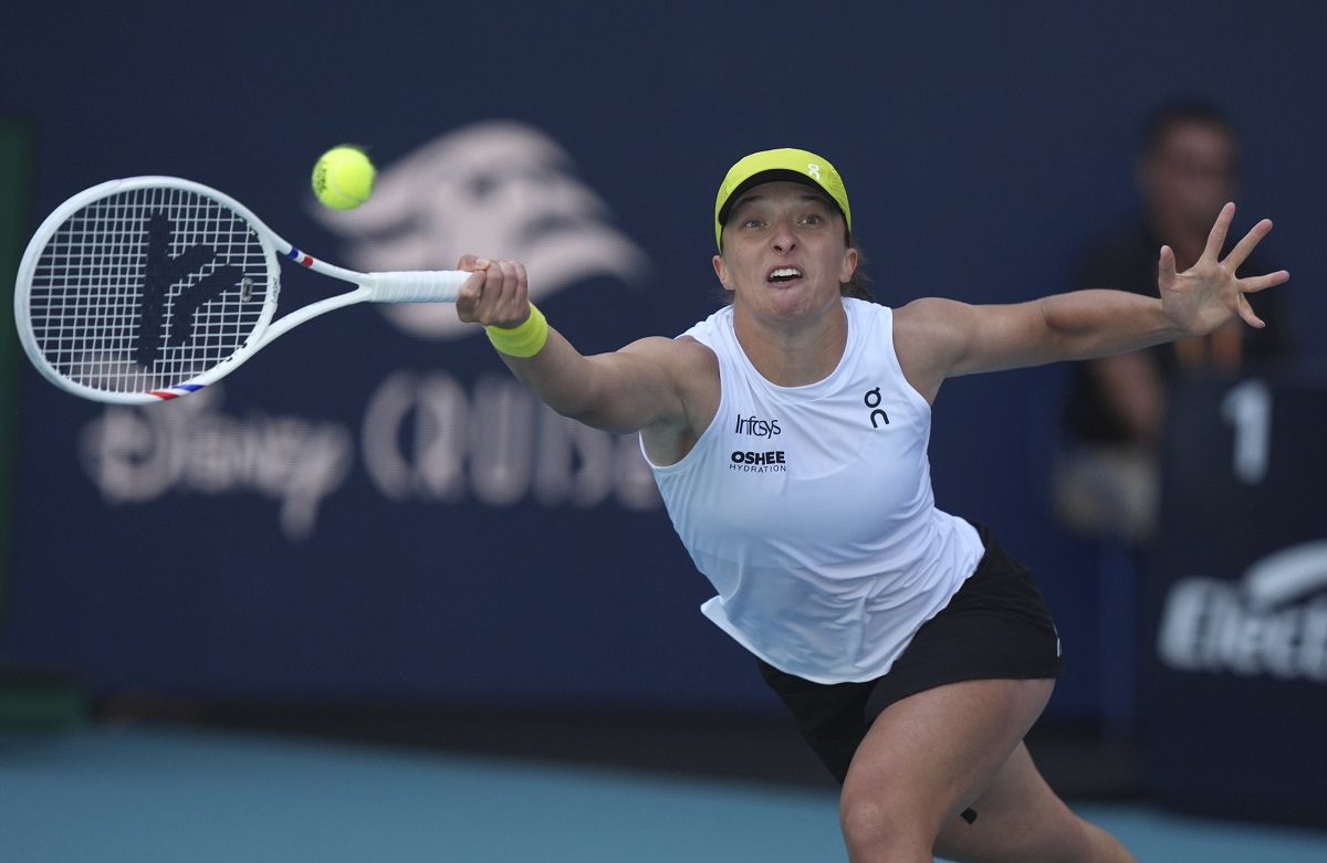 Iga Swiatek, of Poland, hits a return to Caroline Garcia, of France, during the Miami Open tennis tournament, Friday, March 21, 2025, in Miami Gardens, Fla. (AP Photo/Lynne Sladky)