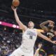 Denver Nuggets center Nikola Jokic (15) pulls in a rebound as Phoenix Suns center Nick Richards defends in the second half of an NBA basketball game Friday, March 7, 2025, in Denver. (AP Photo/David Zalubowski)
