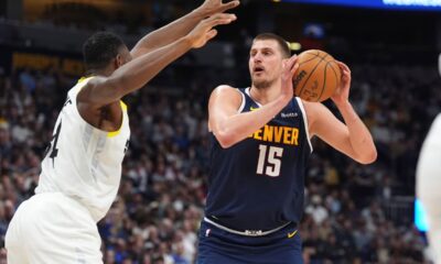 Denver Nuggets center Nikola Jokic, right, goes up for a basket as Utah Jazz center Oscar Tshiebwe, left, defends in the first half of an NBA basketball game Friday, March 28, 2025, in Denver. (AP Photo/David Zalubowski)