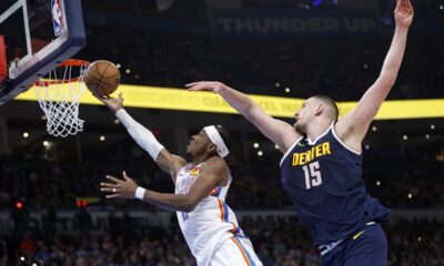 Oklahoma City Thunder guard Shai Gilgeous-Alexander, left, takes the ball to the basket in front of Denver Nuggets center Nikola Jokic (15) during the first half of an NBA basketball game Monday, March 10, 2025, in Oklahoma City. (AP Photo/Nate Billings)