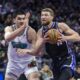 Sacramento Kings center Domantas Sabonis, right, makes a driving layup on Memphis Grizzlies center Zach Edey, left, during the first half of an NBA basketball game Monday, March 17, 2025, in Sacramento, Calif. (AP Photo/Sara Nevis)