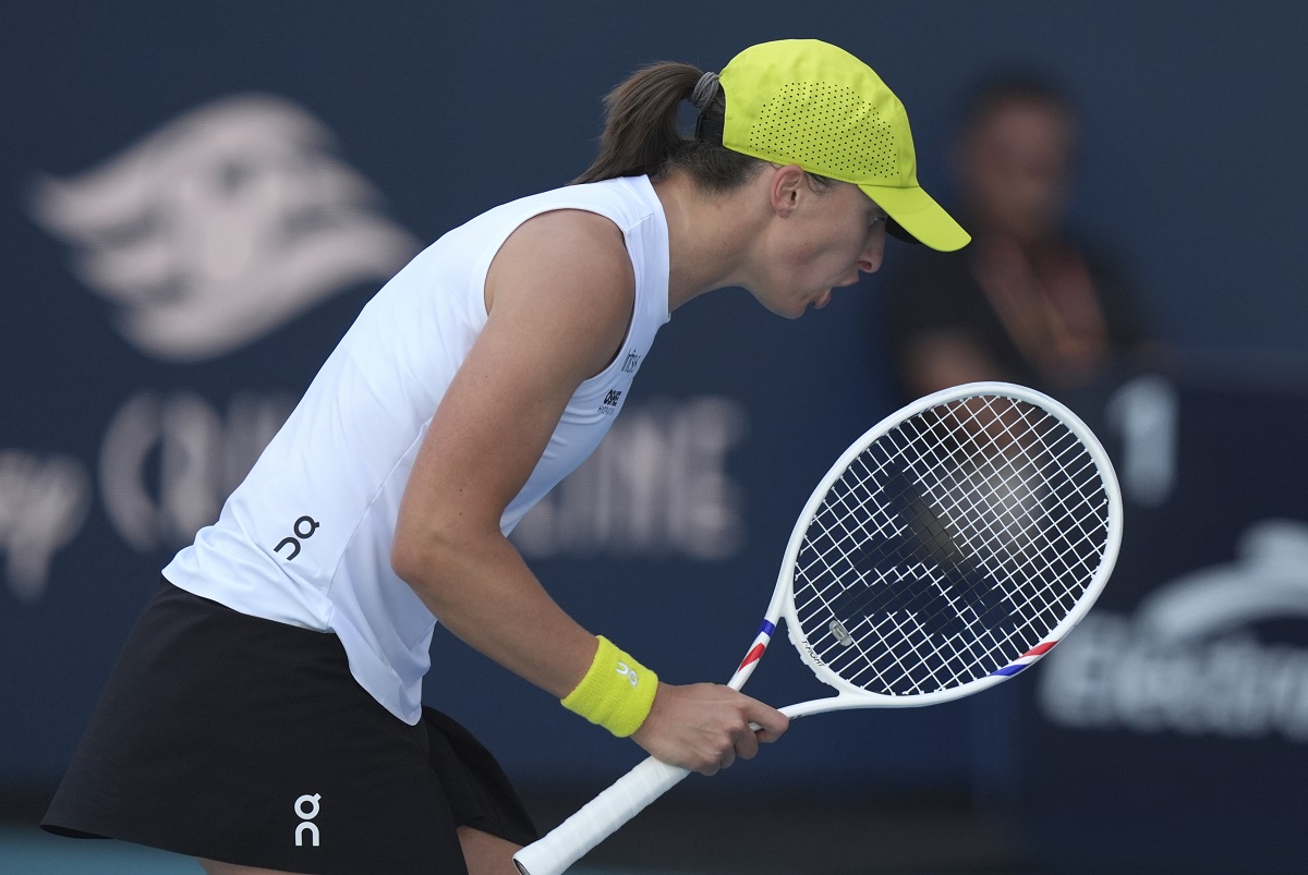 Iga Swiatek, of Poland, reacts after winning a point against Caroline Garcia, of France, during the Miami Open tennis tournament, Friday, March 21, 2025, in Miami Gardens, Fla. (AP Photo/Lynne Sladky)