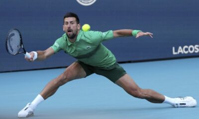 Novak Djokovic, of Serbia, hits a return to Rinky Hijikata, of Australia, during the Miami Open tennis tournament, Friday, March 21, 2025, in Miami Gardens, Fla. (AP Photo/Lynne Sladky)