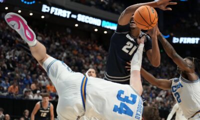 UCLA forward Tyler Bilodeau (34) collides with Utah State center Aubin Gateretse (21) during the first half in the first round of the NCAA college basketball tournament, Thursday, March 20, 2025, in Lexington, Ky. (AP Photo/Brynn Anderson)