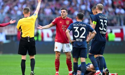 Bayern's Joao Palhinha is shown a red card by referee Christian Dingert during the German Bundesliga soccer match between Bayern Munich and VfL Bochum at the Allianz Arena in Munich, Germany, Saturday, March 8, 2025. (Sven Hoppe/dpa via AP)