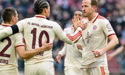 Bayern Munich's Leroy Sane, centre, and teammate Harry Kane high five as they celebrate after Sane scored their side's second goal of the game during the Bundesliga soccer match between Bayern Munich and St. Pauli, at the Allianz Arena stadium in Munich, Germany, Saturday March 29, 2025. (Peter Kneffel/dpa via AP)