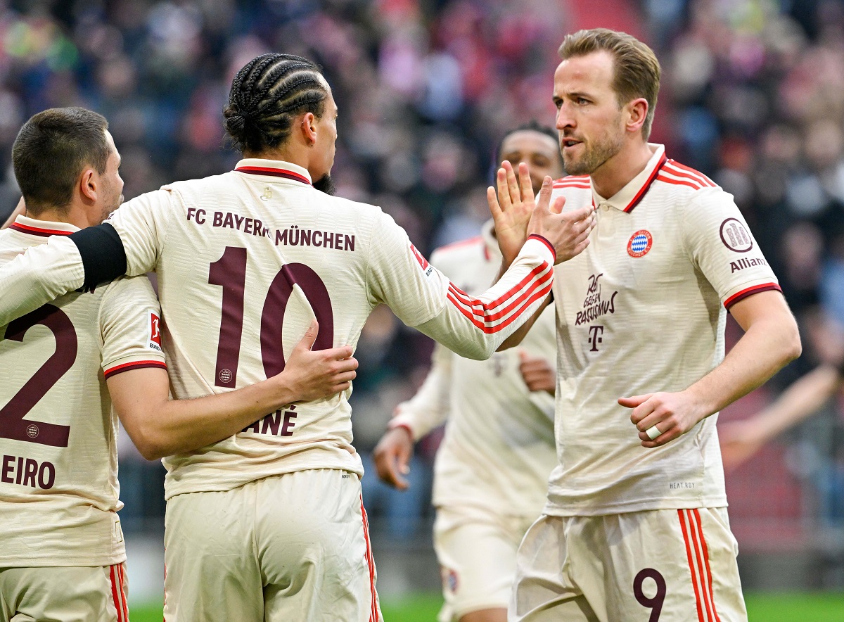 Bayern Munich's Leroy Sane, centre, and teammate Harry Kane high five as they celebrate after Sane scored their side's second goal of the game during the Bundesliga soccer match between Bayern Munich and St. Pauli, at the Allianz Arena stadium in Munich, Germany, Saturday March 29, 2025. (Peter Kneffel/dpa via AP)