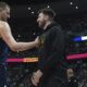 Denver Nuggets center Nikola Jokic, left, greets Los Angeles Lakers guard Luka Doncic, right, in the first half of an NBA basketball game Friday, March 14, 2025, in Denver. (AP Photo/David Zalubowski)