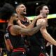 Chicago Bulls' Josh Giddey right, celebrates with teammates Nikola Vucevic center, and Coby White left, after making the winning basket against the Los Angeles Lakers in an NBA basketball game Thursday, March 27, 2025, in Chicago. (AP Photo/Paul Beaty)