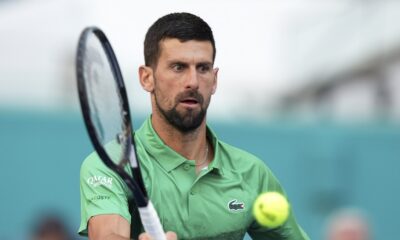 Novak Djokovic, of Serbia, hits a return to Rinky Hijikata, of Australia, during the Miami Open tennis tournament, Friday, March 21, 2025, in Miami Gardens, Fla. (AP Photo/Lynne Sladky)