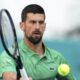 Novak Djokovic, of Serbia, hits a return to Rinky Hijikata, of Australia, during the Miami Open tennis tournament, Friday, March 21, 2025, in Miami Gardens, Fla. (AP Photo/Lynne Sladky)