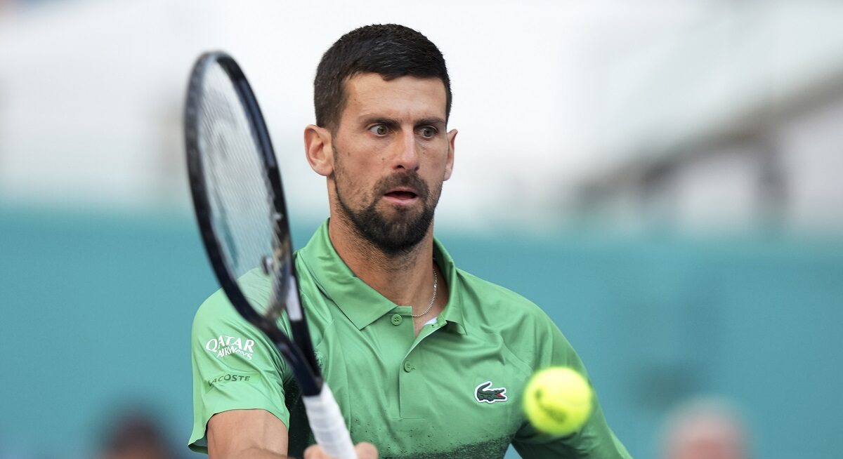Novak Djokovic, of Serbia, hits a return to Rinky Hijikata, of Australia, during the Miami Open tennis tournament, Friday, March 21, 2025, in Miami Gardens, Fla. (AP Photo/Lynne Sladky)