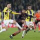 Rangers' Hamza Igamane, center, is challenged by Fenerbahce's Filip Kostic, left, and Fenerbahce's Alexander Djiku during the Europa League round of 16 first leg soccer match between Fenerbahce and Rangers at Sukru Saracoglu stadium in Istanbul, Turkey, Thursday, March 6, 2025. (AP Photo/Khalil Hamra)