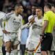 Real Madrid's Kylian Mbappe, center, talks to an assistant referee after a penalty kick by Atletico Madrid's Julian Alvarez during a shootout at the end of the Champions League round of 16, second leg, soccer match between Atletico Madrid and Real Madrid at the Metropolitano stadium in Madrid, Spain, Wednesday, March 12, 2025. (AP Photo/Bernat Armangue)