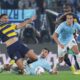 Parma's Simon Sohm, left, in action with Lazio's Mattia Zaccagni, center, and Matteo Guendouzi during the Italian Serie A soccer match between Lazio and Parma at the Rome's Olympic stadium, Italy Monday, April 28, 2025. (Alfredo Falcone/LaPresse via AP)