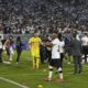Arturo Vidal of Chile's Colo Colo talks to fans who invaded the field during a Copa Libertadores Group E soccer match between Chile's Colo Colo and Brazil's Fortaleza at the Monumental stadium in Santiago, Chile, Thursday, April 10, 2025. (AP Photo/Esteban Felix)