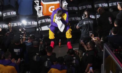 An emotional Los Angeles Lakers' Luka Doncic puts a towel to his face as a vide tribute is played in the arena thanking the former Dallas Mavericks player before an NBA basketball game in Dallas, Wednesday, April 9, 2025. (AP Photo/Julio Cortez)