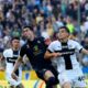Juventus' Dusan Vlahovic, left, and Parma's Giovanni Leoni in action during the Serie A soccer match between Parma and Juventus at the Ennio Tardini Stadium, Italy, Wednesday April 23, 2025. (Paola Garbuio/LaPresse via AP)