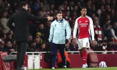 Arsenal's Gabriel, right, leaves the pitch after picking up an injury during the English Premier League soccer match between Arsenal and Fulham at Emirates stadium in London, Tuesday, April 1, 2025. (John Walton/PA via AP)