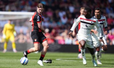 Bournemouth's Alex Scott, left, and Manchester United's Kobbie Mainoo battle for the ball during the English Premier League match at Vitality Stadium, Bournemouth, England, Sunday, April 27, 2025. (Adam Davy/PA via AP)