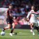 Bournemouth's Alex Scott, left, and Manchester United's Kobbie Mainoo battle for the ball during the English Premier League match at Vitality Stadium, Bournemouth, England, Sunday, April 27, 2025. (Adam Davy/PA via AP)