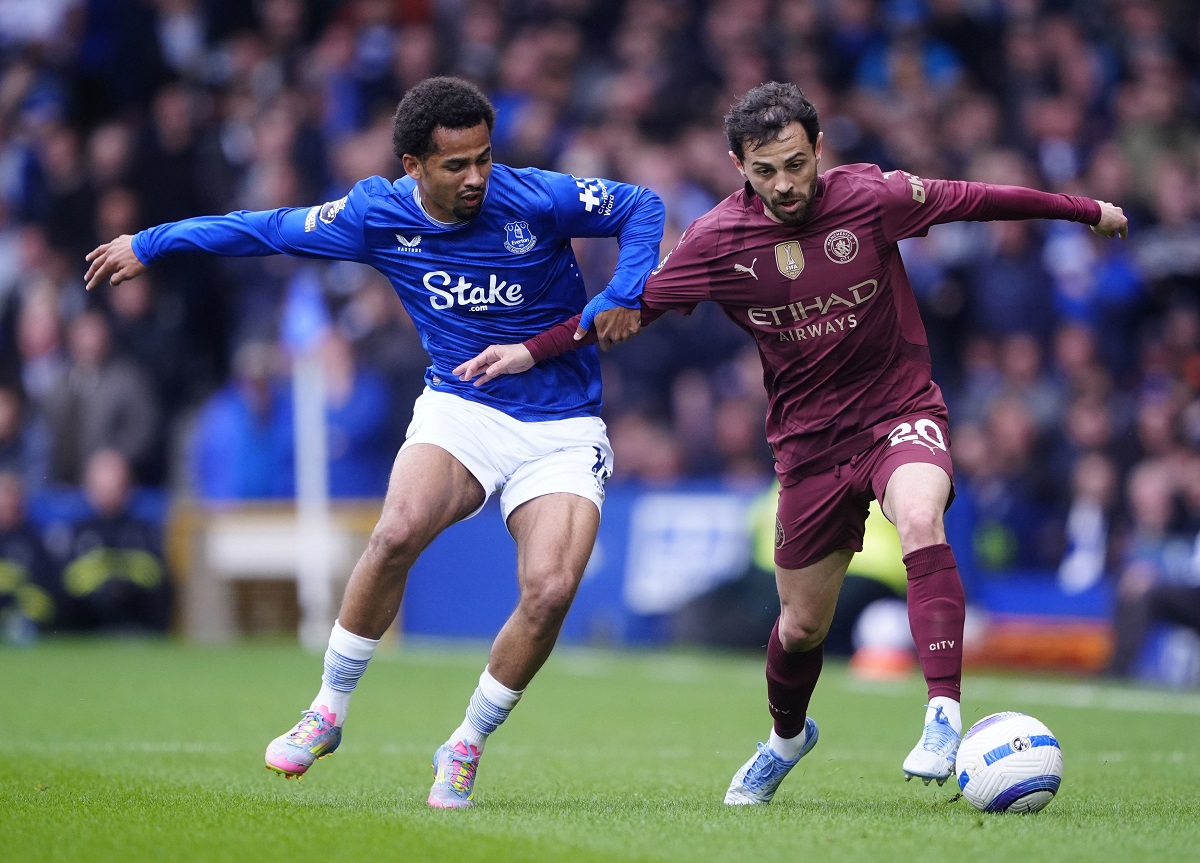 Everton's Iliman Ndiaye, left, and Manchester City's Bernardo Silva battle for the ball during the English Premier League soccer match between Everton and Manchester City at Goodison Park, Liverpool, England, Saturday April 19, 2025. (Peter Byrne/PA via AP)