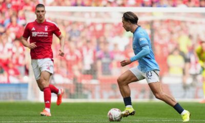Manchester City's Jack Grealish in action in front of Nottingham Forest's Nikola Milenkovic during the English FA Cup semifinal soccer match between Nottingham Forest and Manchester City at Wembley stadium in London, Sunday, April 27, 2025. (AP Photo/Kirsty Wigglesworth)