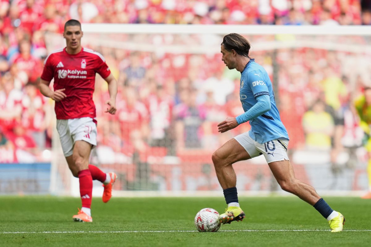 Manchester City's Jack Grealish in action in front of Nottingham Forest's Nikola Milenkovic during the English FA Cup semifinal soccer match between Nottingham Forest and Manchester City at Wembley stadium in London, Sunday, April 27, 2025. (AP Photo/Kirsty Wigglesworth)