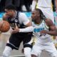 Milwaukee Bucks' Giannis Antetokounmpo, left, tries to keep control of the ball as Indiana Pacers' Aaron Nesmith, right, defends during the first half of a first-round NBA basketball playoff game, Saturday, April 19, 2025, in Indianapolis. (AP Photo/Michael Conroy)