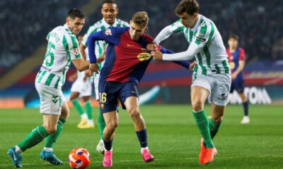 Barcelona's Fermin Lopez, center, is challenged by Betis' Romain Perraud, left, and Diego Llorente during a Spanish La Liga soccer match between Barcelona and Real Betis at the Lluis Companys Olympic stadium in Barcelona, Spain, Saturday, April 5, 2025. (AP Photo/Joan Monfort)