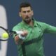 Novak Djokovic of Serbia hits a return to Sebastian Korda during the Miami Open tennis tournament, Thursday, March 27, 2025, in Miami Gardens, Fla. (AP Photo/Marta Lavandier)