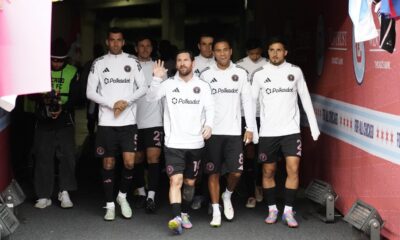 Inter Miami forward Lionel Messi, center, waves to fans as he enters the field with teammates before an MLS soccer game against the Chicago Fire, Sunday, April 13, 2025, in Chicago. (AP Photo/David Banks)