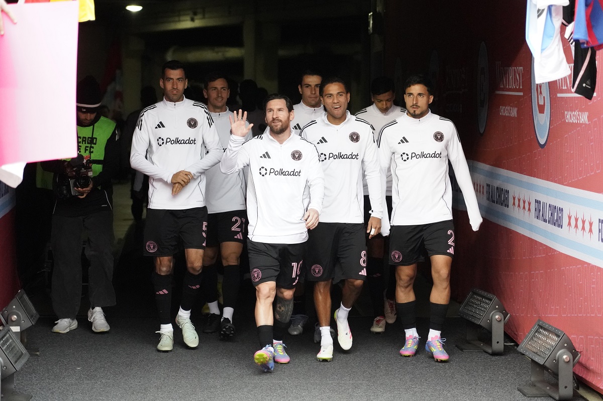 Inter Miami forward Lionel Messi, center, waves to fans as he enters the field with teammates before an MLS soccer game against the Chicago Fire, Sunday, April 13, 2025, in Chicago. (AP Photo/David Banks)
