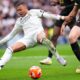 Real Madrid's Kylian Mbappe, left, falls chased by Valencia's Cesar Tarrega during a Spanish La Liga soccer match between Real Madrid and Valencia at the Santiago Bernabeu stadium in Madrid, Spain, Saturday, April 5, 2025. (AP Photo/Manu Fernandez)