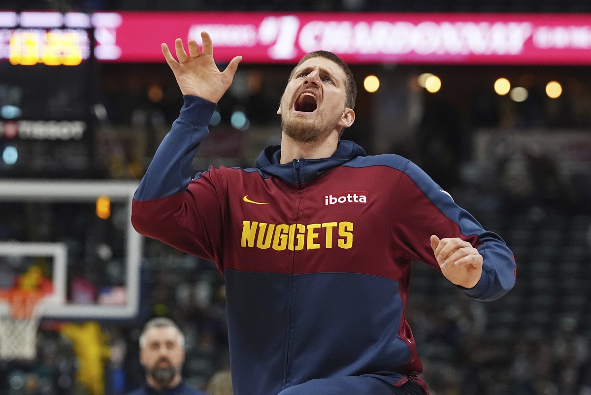 Denver Nuggets center Nikola Jokic jokes with teammates as they warm up to face the Indiana Pacers in the first half of an NBA basketball game Sunday, April 6, 2025, in Denver. (AP Photo/David Zalubowski)