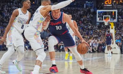Los Angeles Clippers guard Bogdan Bogdanovic, right, struggles to drive to the basket as Denver Nuggets guard Russell Westbrook defends in the second half of Game 5 of an NBA basketball playoff series Tuesday, April 29, 2025, in Denver. (AP Photo/David Zalubowski)