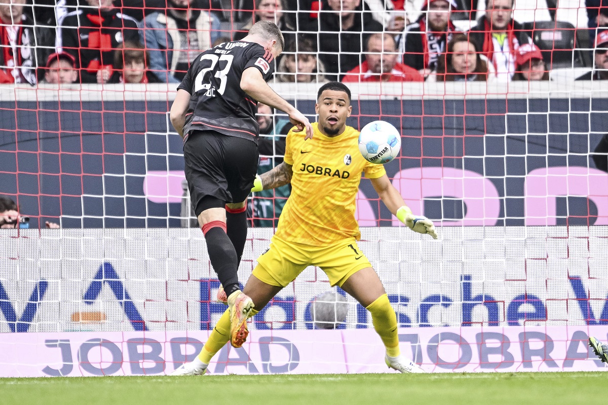 Berlin's Andrej Ilic, left, scores his side's second goal during the German Bundesliga soccer match between SC Freiburg - 1. FC Union Berlin at The Europa-Park Stadion in Freiburg, Germany, Sunday, March 30, 2025. (Harry Langer/dpa via AP)
