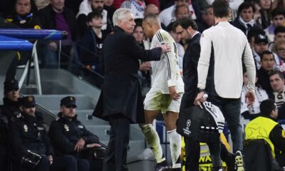 Real Madrid's Kylian Mbappe walks past Real Madrid's head coach Carlo Ancelotti after being replaced during the Champions League quarterfinals second leg soccer match between Real Madrid and Arsenal at the Santiago Bernabeu stadium in Madrid, Wednesday, April 16, 2025. (AP Photo/Manu Fernandez)