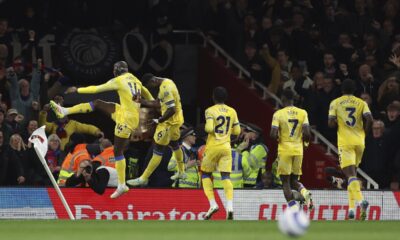Crystal Palace's Jean-Philippe Mateta, left, celebrates with teammates after scoring his sides second goal during the English Premier League soccer match between Arsenal and Crystal Palace at Emirates stadium in London, Wednesday, April 23, 2025. (AP Photo/Ian Walton)