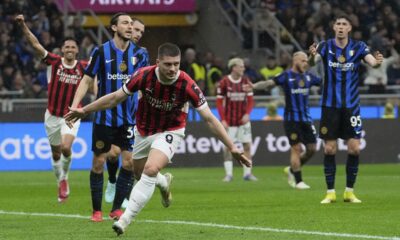 AC Milan's Luka Jovic celebrates after scoring during the Italian Cup semifinal second leg soccer match between Inter Milan and AC Milan at the San Siro stadium in Milan, Italy, Wednesday, April 23, 2025. (AP Photo/Luca Bruno)