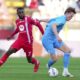 Napoli's Scott McTominay, right, and Monza's Jean-Daniel Akpa Akpro in action during the Serie A soccer match between Monza and Napoli at U-Power Stadium in Monza, Italy, Saturday April 19, 2025. (Spada/LaPresse via AP)