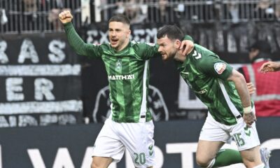 Werder's Oliver Burke, right, celebrates with Romano Schmid after scoring his side's first goal during the Bundesliga soccer match between Werder Bremen and Eintracht Frankfurt at the Weser Stadium in Bremen, Saturday, April 5, 2025. (Carmen Jaspersen/dpa via AP)