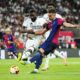 Real Madrid's Antonio Rudiger, left, challenges for the ball with Barcelona's Ferran Torres during the Spanish Copa del Rey final soccer match between Barcelona and Real Madrid at Estadio de La Cartuja stadium in Seville, Spain, Sunday, April 27, 2025. (AP Photo/Jose Breton)