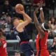 Los Angeles Clippers guard Bogdan Bogdanovic, center, shoots as Houston Rockets forward Tari Eason, left, and forward Jae'Sean Tate defend during the first half of an NBA basketball game Wednesday, April 9, 2025, in Inglewood, Calif. (AP Photo/Mark J. Terrill)