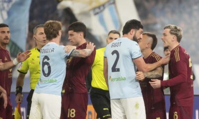 Players argue during the Italian Serie A soccer match between Lazio and Roma at Rome's Olympic stadium, Sunday, April 13, 2025. (AP Photo/Gregorio Borgia)