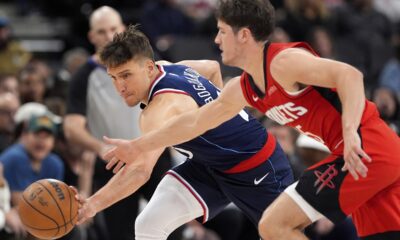 Los Angeles Clippers guard Bogdan Bogdanovic, left, and Houston Rockets guard Reed Sheppard reach for a loose ball during the second half of an NBA basketball game Wednesday, April 9, 2025, in Inglewood, Calif. (AP Photo/Mark J. Terrill)