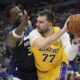 Los Angeles Lakers guard Luka Doncic (77) looks to pass as Minnesota Timberwolves forward Julius Randle (30) defends during the second half of Game 3 of an NBA basketball first-round playoff series, Friday, April 25, 2025, in Minneapolis. (AP Photo/Abbie Parr)